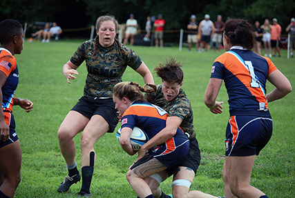 Marine Corps LCpl Kerra Wieberg of Marine Corps Base Camp Pendleton, Calif. collides with Coast Guard Lt. J.G. Sheila Bertrand of Washington, D.C. during the opening match of the 2021 Armed Forces Rugby Championship held in conjunction with the 2021 Cape Fear Rugby Sevens Tournament, held from 24-28 June. Service members from the Army, Marine Corps, Navy, Air Force (with Space Force personnel) and Coast Guard battle it out for gold. (Department of Defense Photo, Released)